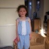A child's jumpsuit made out of an old men's shirt.
