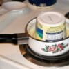 Tub of butter upside down in saucepan