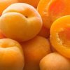 Pile of apricots, some whole, some cut in half.