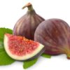 Two figs with one cut sitting on a leaf.