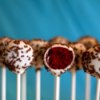 Valentine's Cake Pops, A row of cake pops with Red Velvet centers.