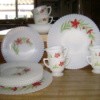 Tableware set: white with red flowers and leaf spray around half of outside edge. The edges appear to be ruffled.
