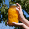 A jar of canned peaches.