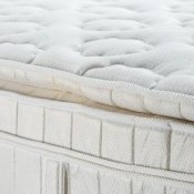 Up close photo of a pillow top mattress.