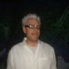 Closeup of face with spiked hair, glasses, and fake teeth.