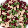 A salad made with kidney, wax and green beans, with onion and dressing.