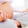 Doing Yoga During Pregnancy, A woman doing yoga during pregnancy.