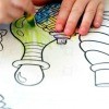 Child Coloring in a Coloring Book