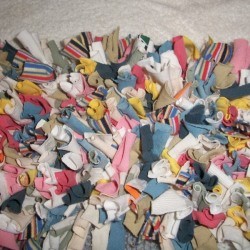 A latch hook rug made from recycled fabrics.
