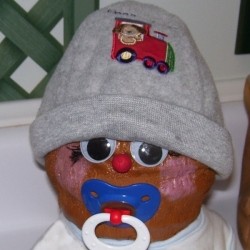 coconut with baby hat, bib, and pacifier