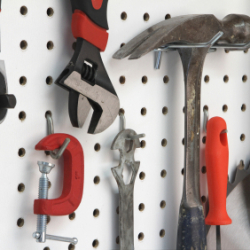 Photo of tools hung a peg board.