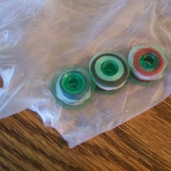 Three bobbins with string on them.