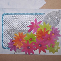 Card embellished with a large cluster of the cut out gift bag flowers. The flowers in various colors adorn the lower right corner of the card. The cord handle is used to complete a partial rectangular shape on the left side and upper left corner. 