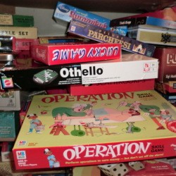 Messy pile of board game boxes.