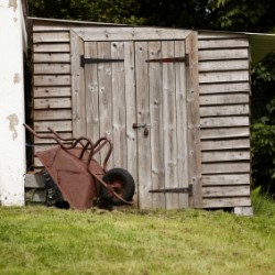 A garden shed built slightly on a hill.