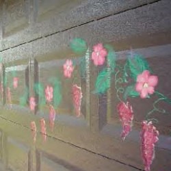 Flowers painted on a garage door.