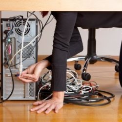 Photo of the wires behind a computer desk.