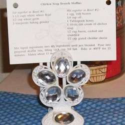Decorative hair clip with clear faceted stones holding recipe.