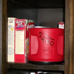 Upside down Folger's container used to store oats.