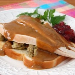 Photo of brown gravy on a turkey sandwich.