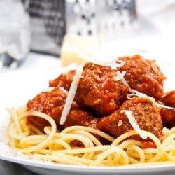 A plate of spaghetti with meatballs.