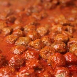 Meatballs cooking in sauce.