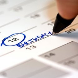 Someone Writing Birthday on Calendar