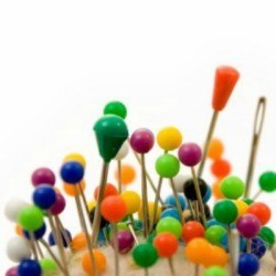 Pins and needles stuck into an almost unseen pin cushion.