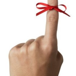 Red Ribbon Tied Around Index Finger