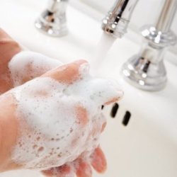A person washing their hands with soap.