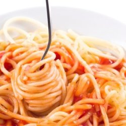 Fork wound with spaghetti and ketsup meal.