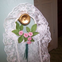 Closeup of TP holder hanging on door knob.