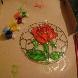 Cardboard box under painted suncatcher project.