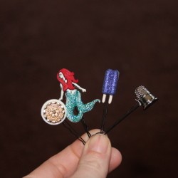 Finished button bobby pin hair accessory.
