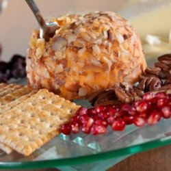 Cheese ball on plate with crackers and berries