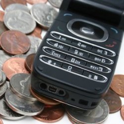 Cell phone sitting on top of a pile of change.