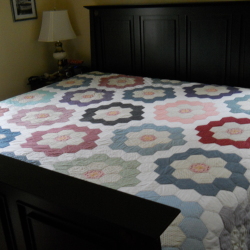 Flower Garden Quilt on bed.