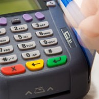 Swiping a credit card through a machine.