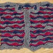 A striped crocheted baby sweater.