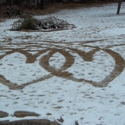 Two hearts caused by tire tracks in the snow.