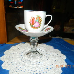A pedestal server for a tea cup.