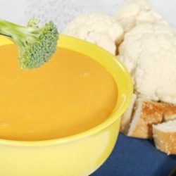 Broccoli Being Dipped in Cheese