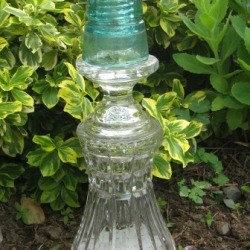 Decorative glass garden ornament made from reused glass items.