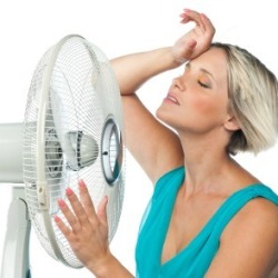 Woman Cooling Off in Front of Fan