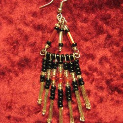 Completed earring on red background.