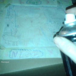 Spraying hairspray on a drawing.