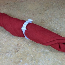 A napkin ring made from plastic vampire teeth.