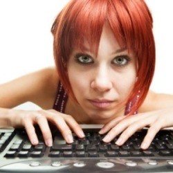 A woman who is working on the computer.