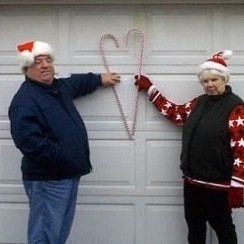 A couple making a heart with two candy canes