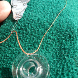 Thread pulled through bobbin hole.
